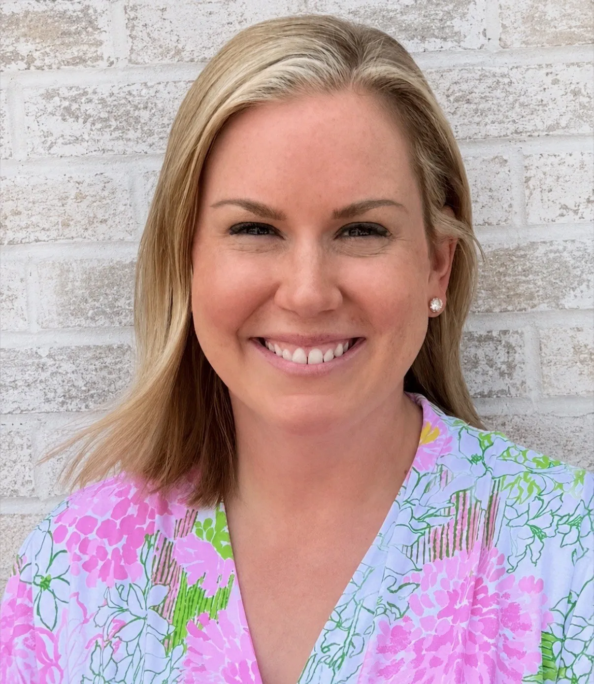 Emily Waldren, LISW, smiling in a floral top